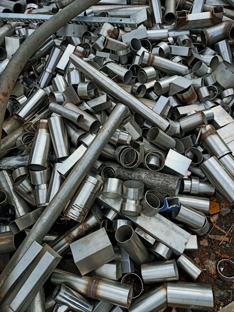 A large heap of assorted metal pipes and tubes in Indore, showcasing industrial materials.