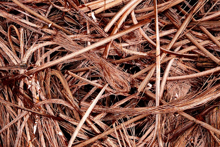 Close-up view of intertwined copper wires ready for recycling, emphasizing industrial reuse.